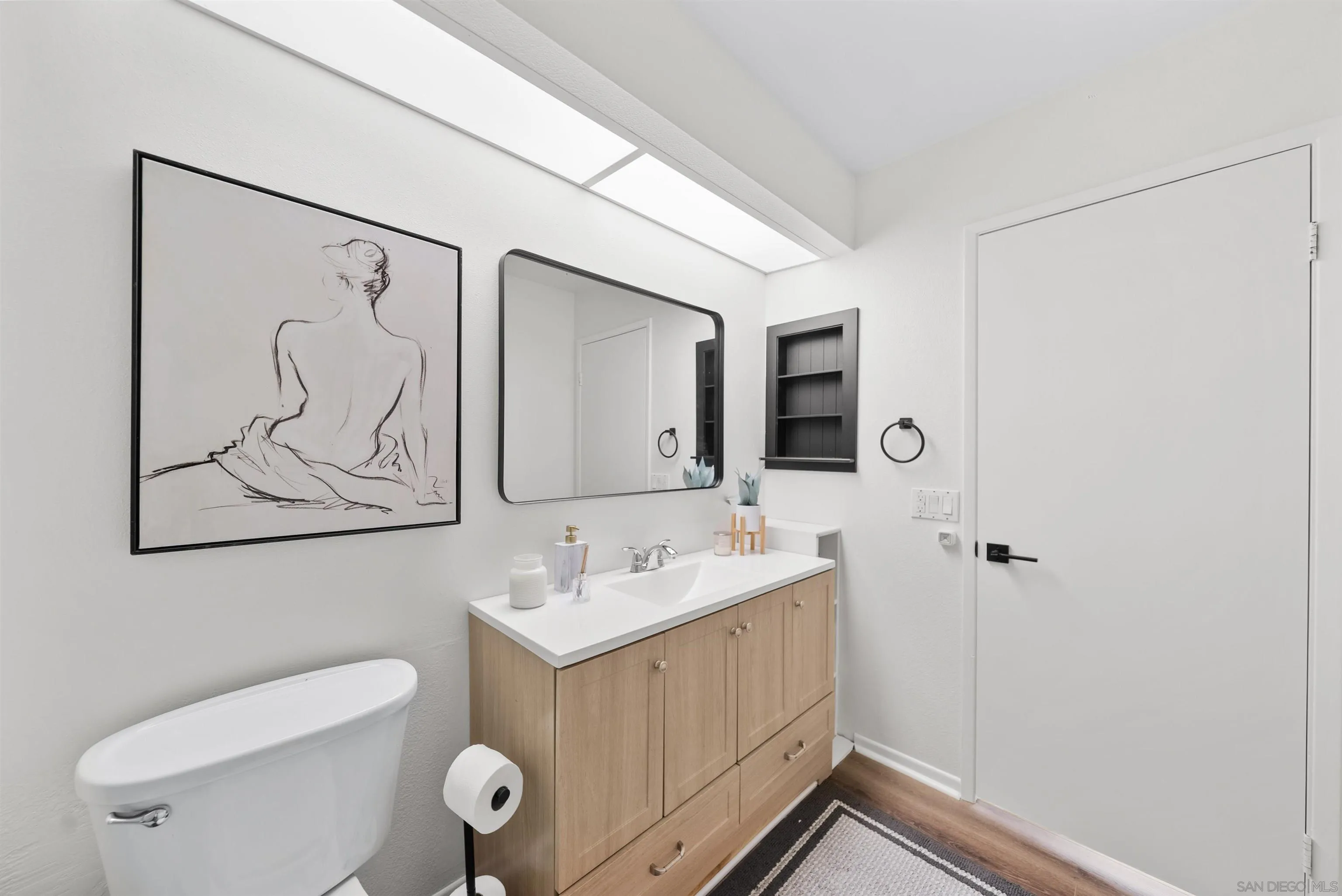 2291 Cabo Bahia Chula Vista, CA 91914 - Photo 31 of 45 a bathroom with a toilet a sink and mirror