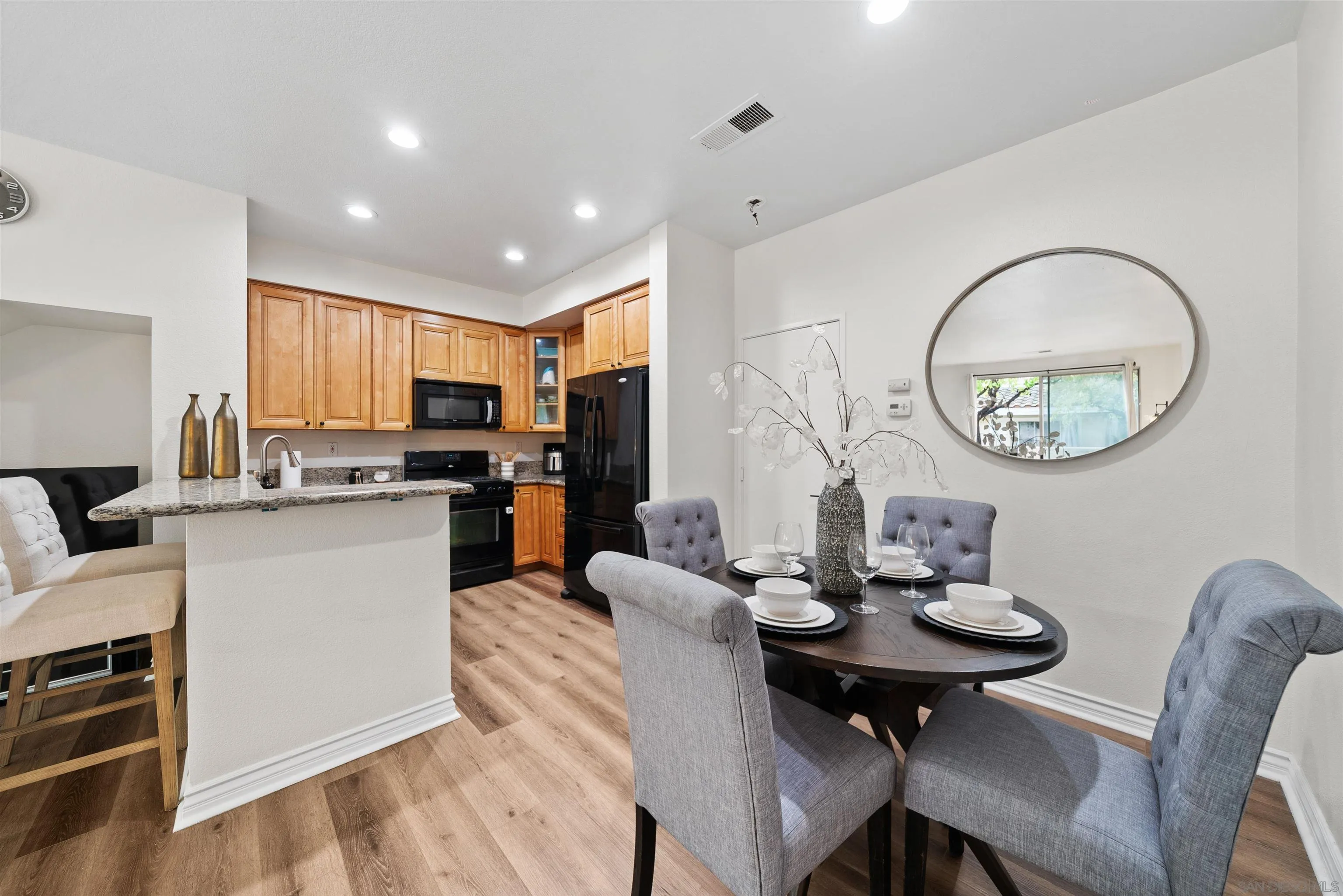 2291 Cabo Bahia Chula Vista, CA 91914 - Photo 7 of 45 a kitchen with a dining table chairs and refrigerator