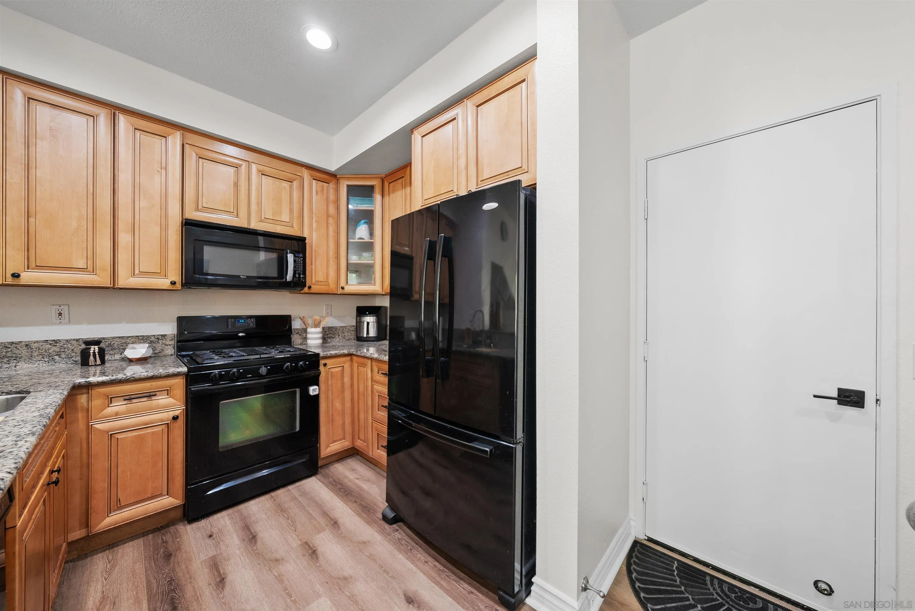 2291 Cabo Bahia Chula Vista, CA 91914 - Photo 8 of 45 a kitchen with stainless steel appliances granite countertop a refrigerator stove and microwave