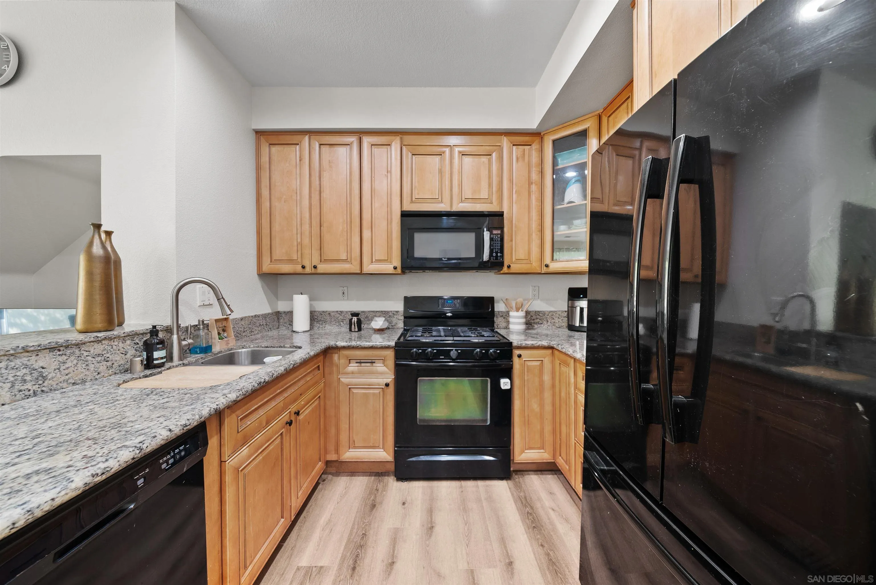 2291 Cabo Bahia Chula Vista, CA 91914 - Photo 9 of 45 a kitchen with stainless steel appliances granite countertop a stove a sink and a refrigerator