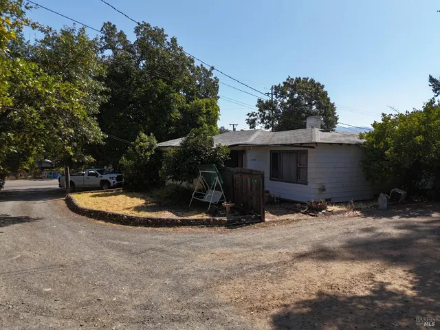 a view of a street with trees on both side of it