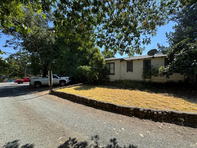 a backyard of a house with yard and outdoor seating