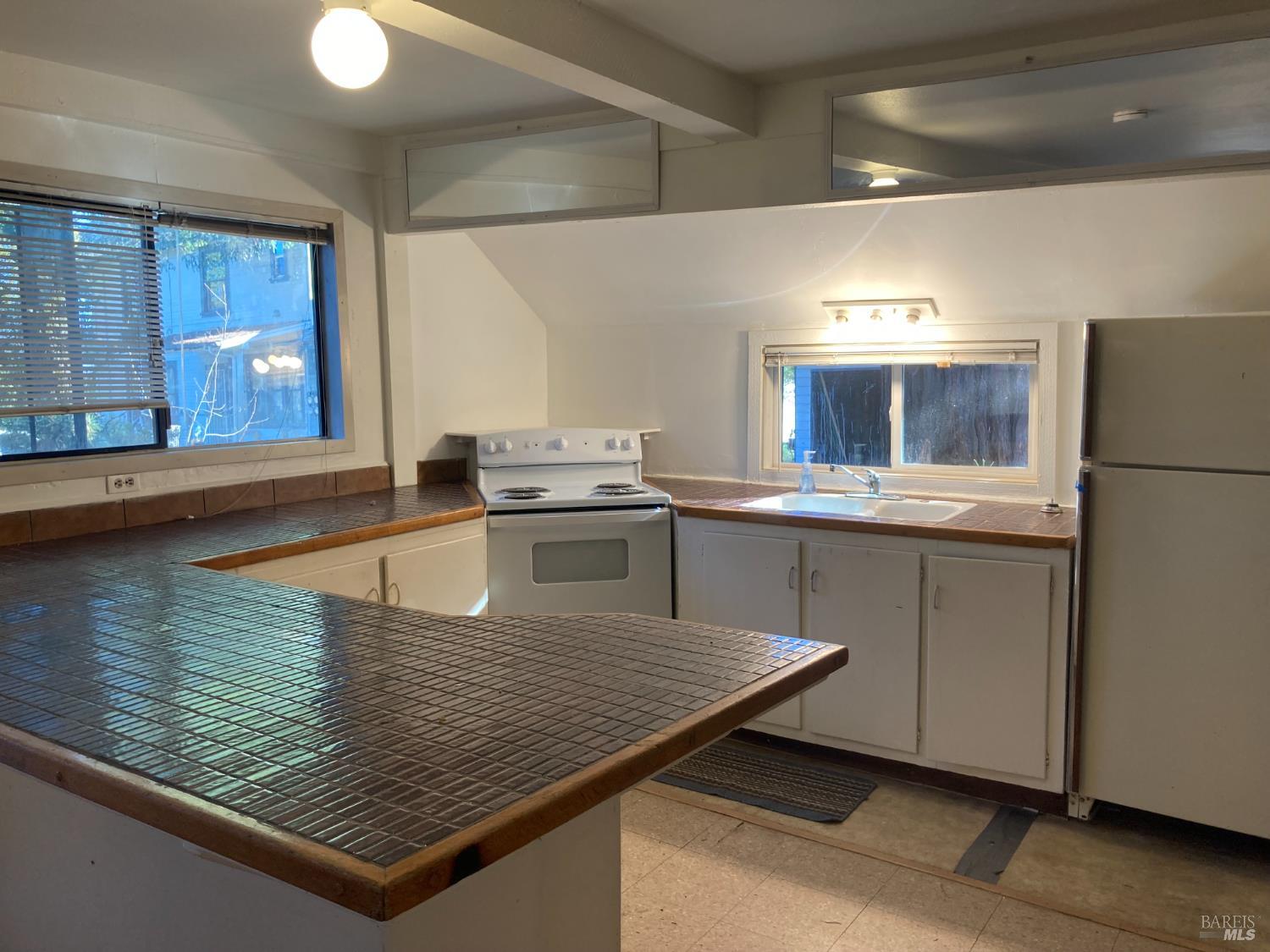 2140 South State Street Ukiah, CA 95482 - Photo 34 of 67 a kitchen with stainless steel appliances granite countertop a sink stove and refrigerator