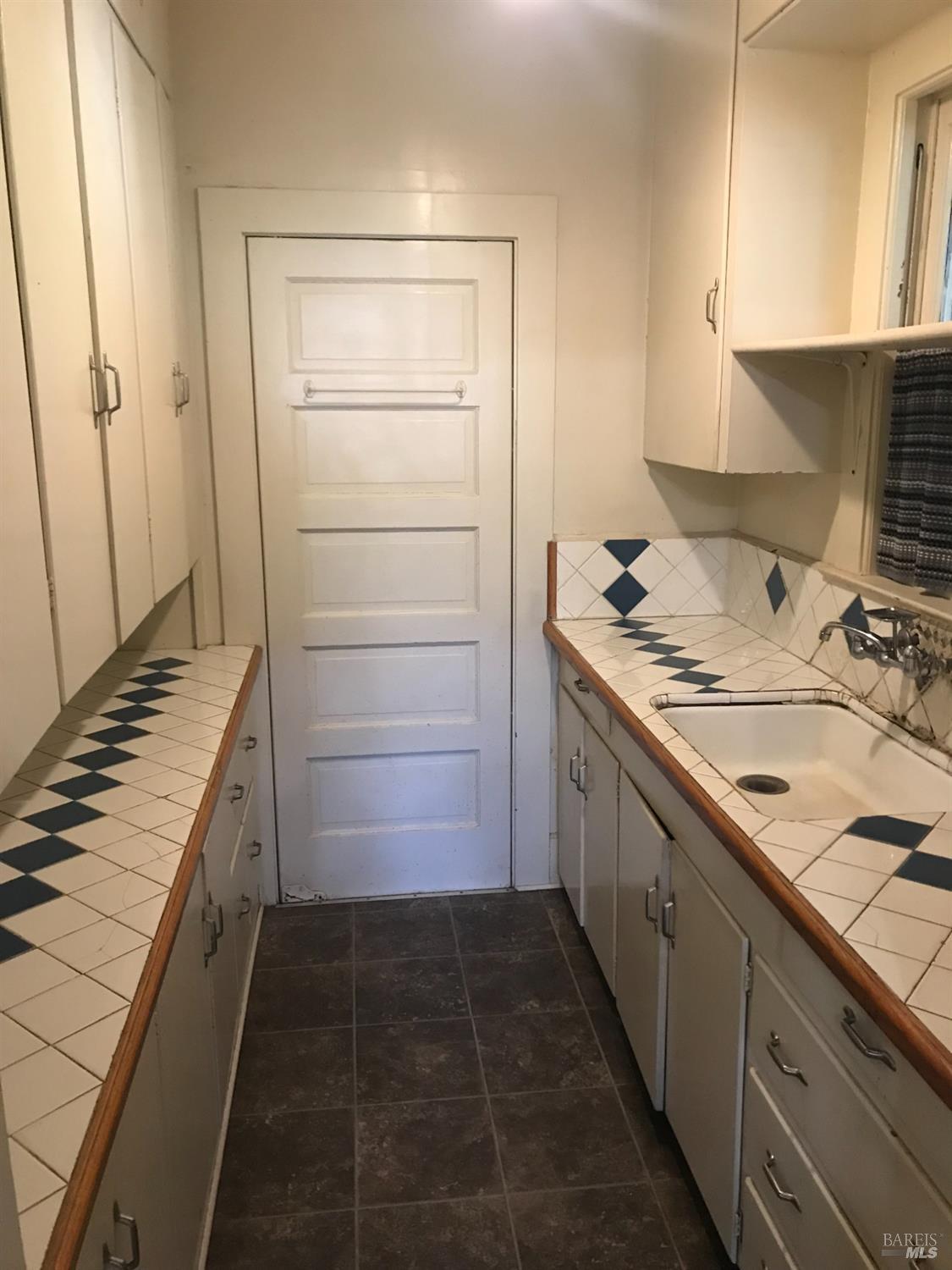 2140 South State Street Ukiah, CA 95482 - Photo 63 of 67 a bathroom with a granite countertop sink and a washing machine