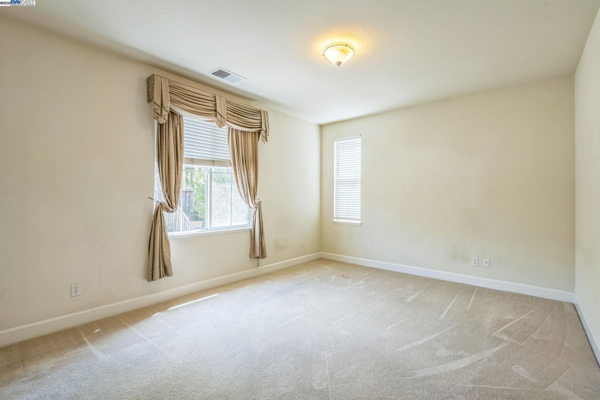 5591 Newfields Lane Dublin, CA 94568 - Photo 15 of 24 an empty room with windows
