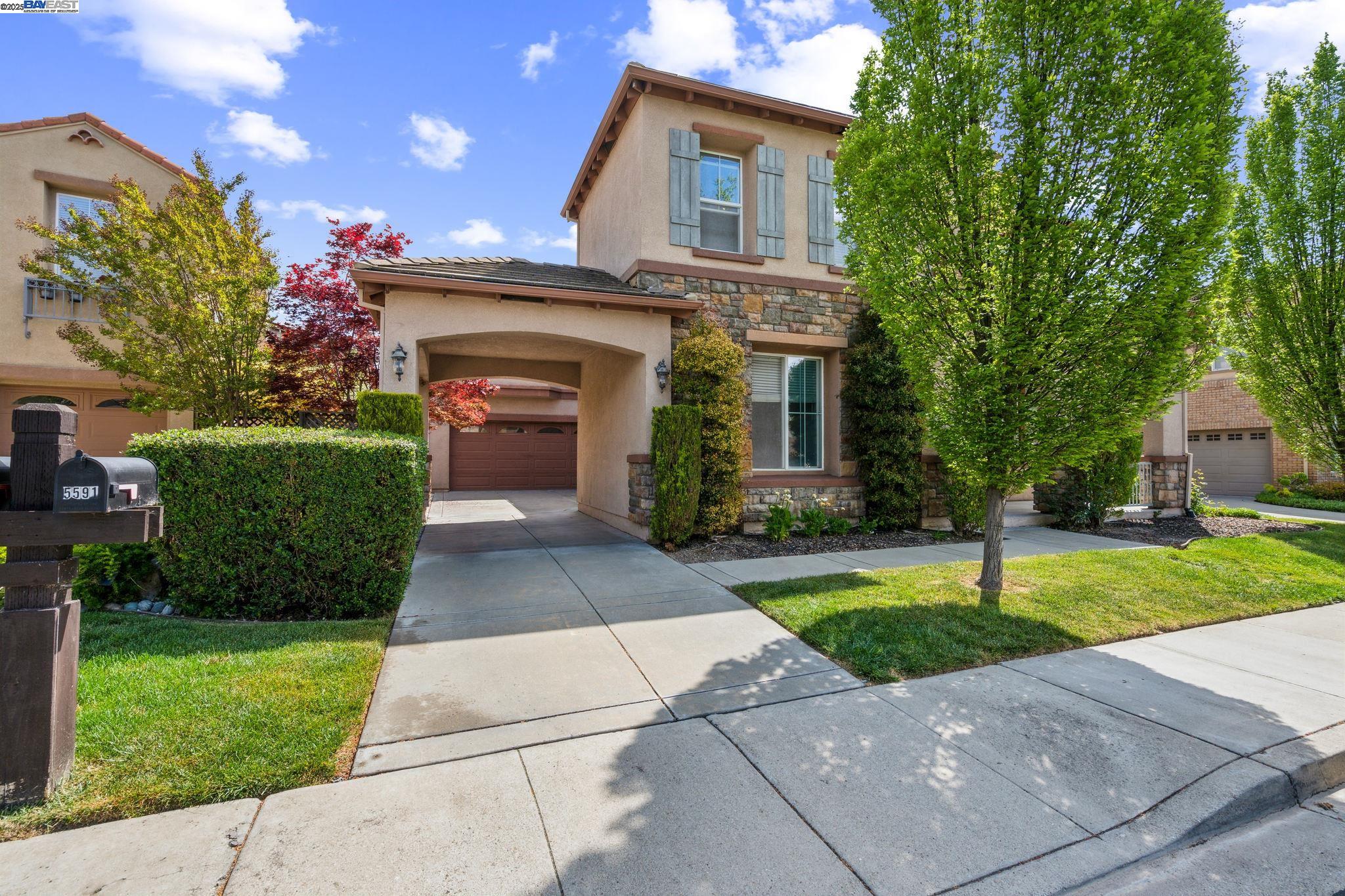 5591 Newfields Lane Dublin, CA 94568 - Photo 2 of 24 a front view of a house with a garden and yard