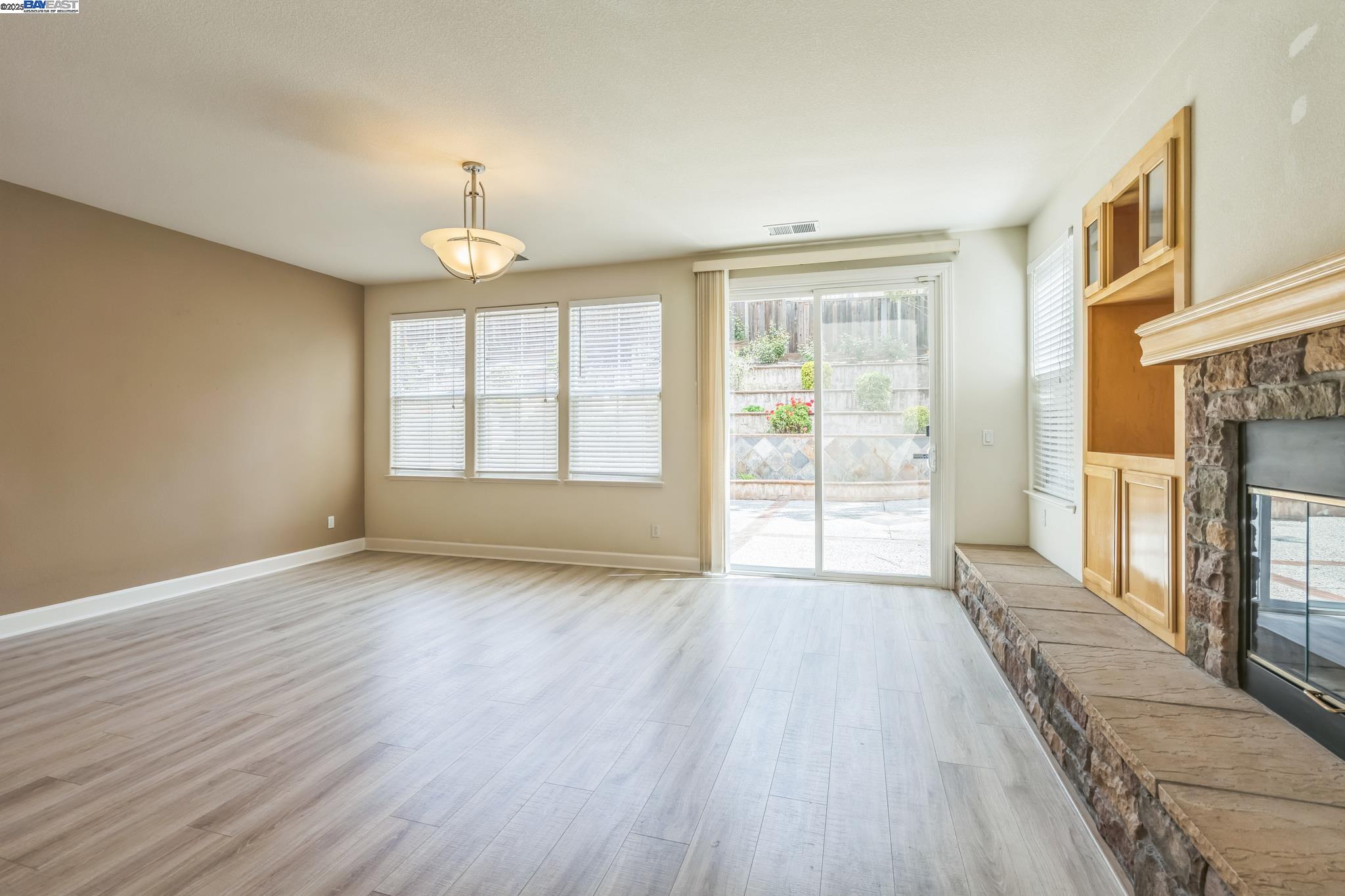 5591 Newfields Lane Dublin, CA 94568 - Photo 8 of 24 a view of an empty room with a window and wooden floor