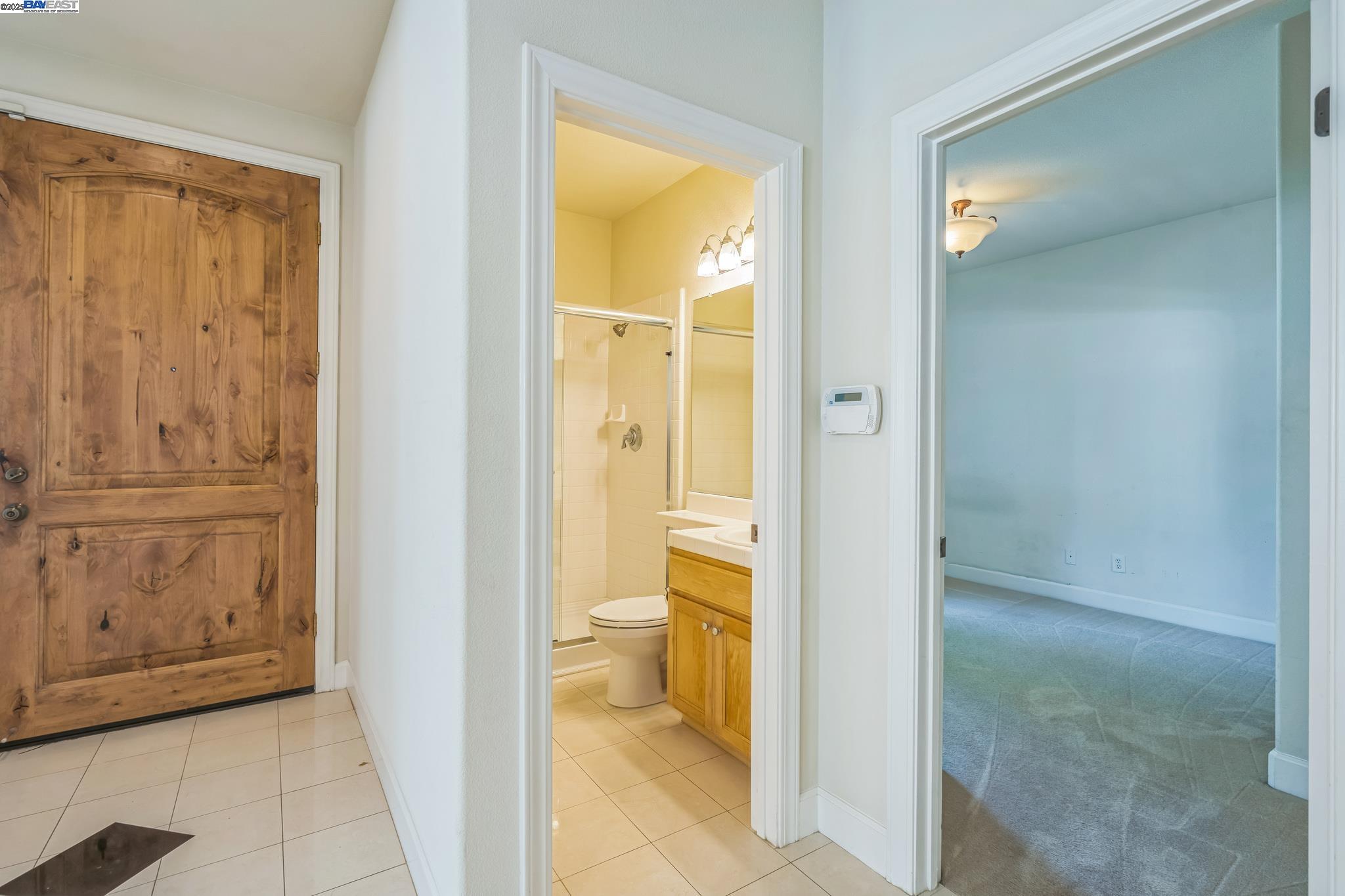 5591 Newfields Lane Dublin, CA 94568 - Photo 9 of 24 a view of a bathroom with a glass door and a bathroom