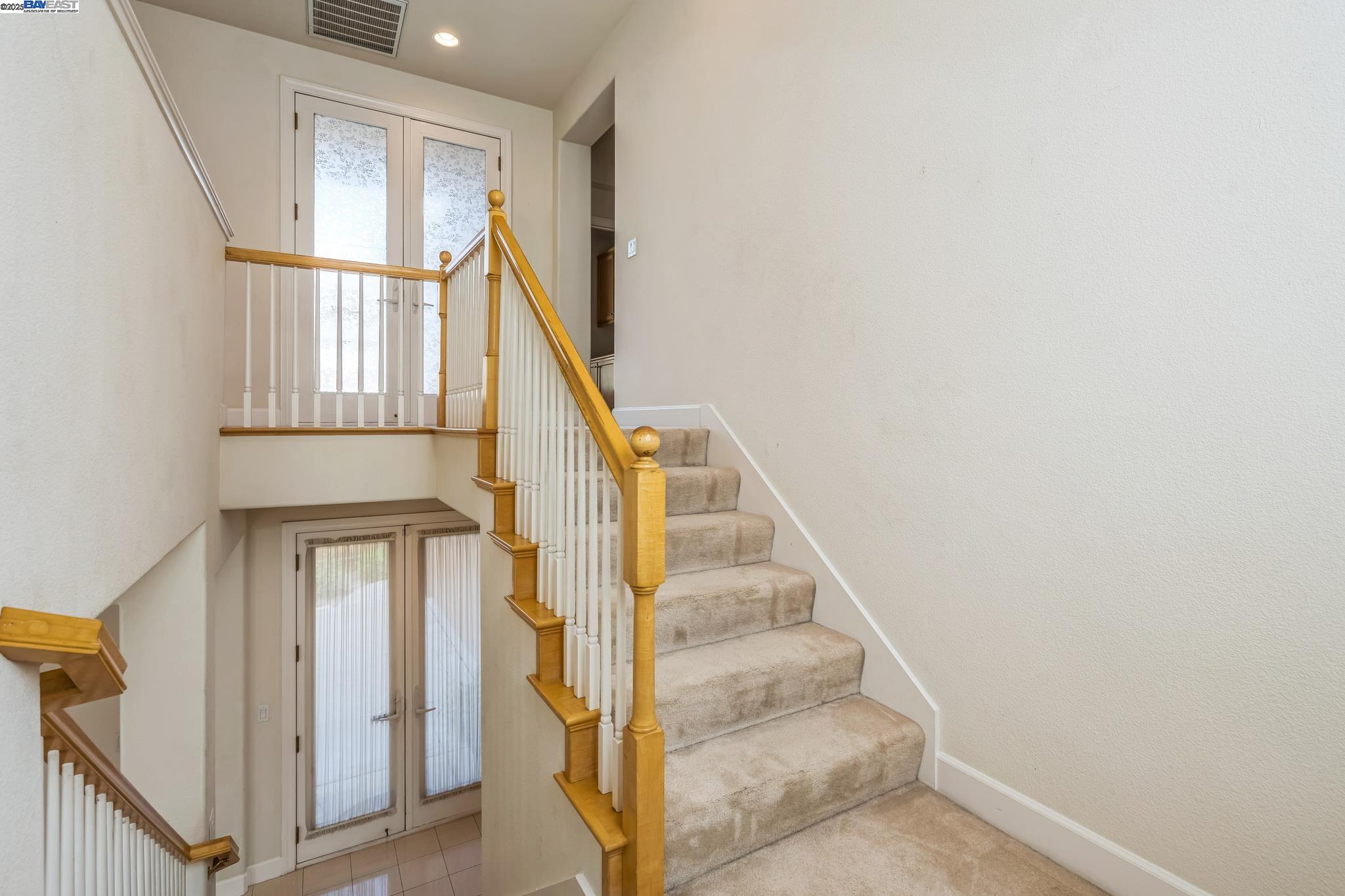 5591 Newfields Lane Dublin, CA 94568 - Photo 10 of 24 a view of staircase with wooden floor and a front door