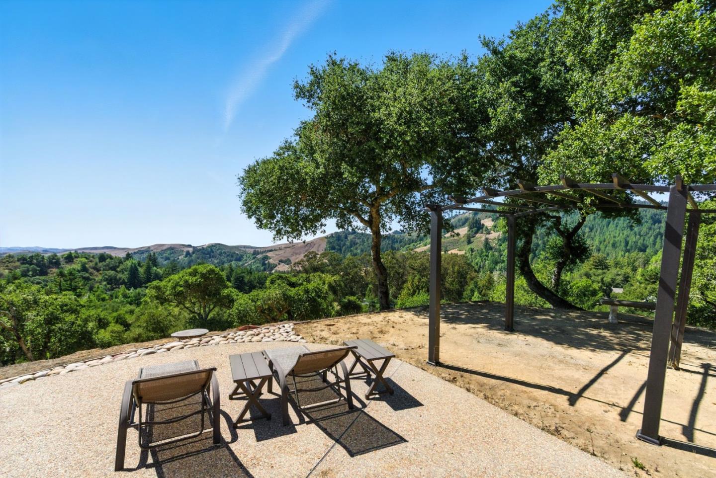 12725 Old La Honda Road Woodside, CA 94062 - Photo 4 of 30 a view of a patio with a table and chairs under an umbrella