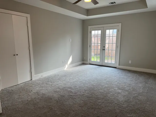 a spacious bathroom with a mirror sink and mirror