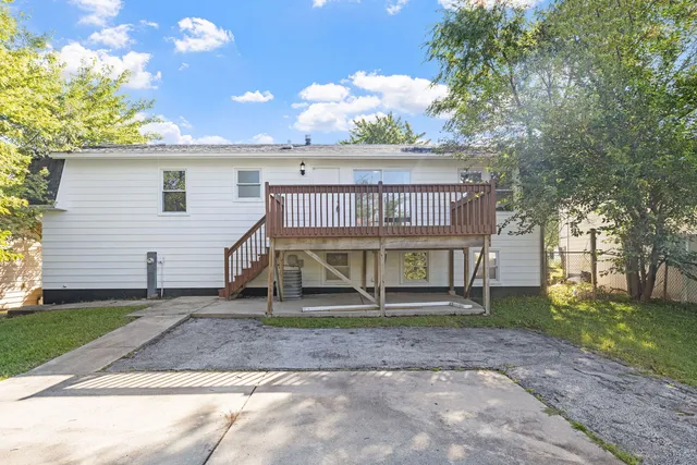 a view of a house with a yard and a tree