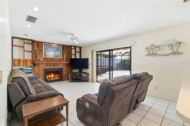 a living room with furniture flat screen tv and a fireplace