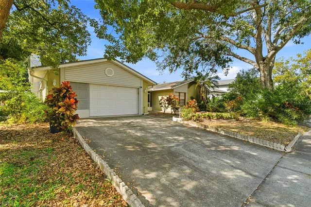 a front view of a house with a yard and a garage