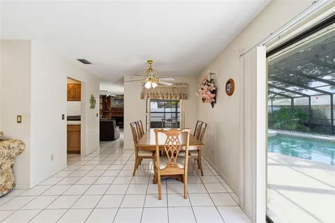 a view of a dining room with furniture and a floor to ceiling window