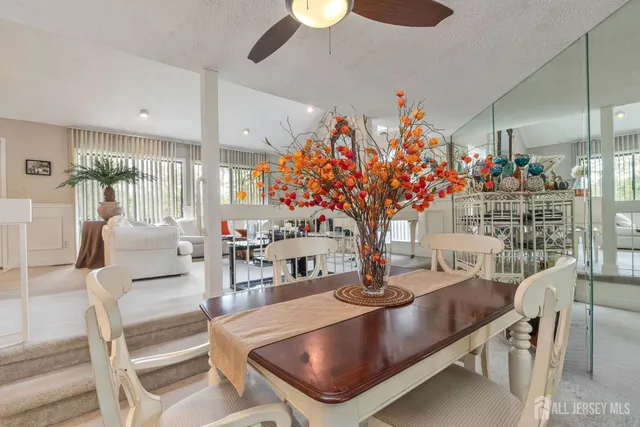 a living room with fireplace furniture and a potted plant