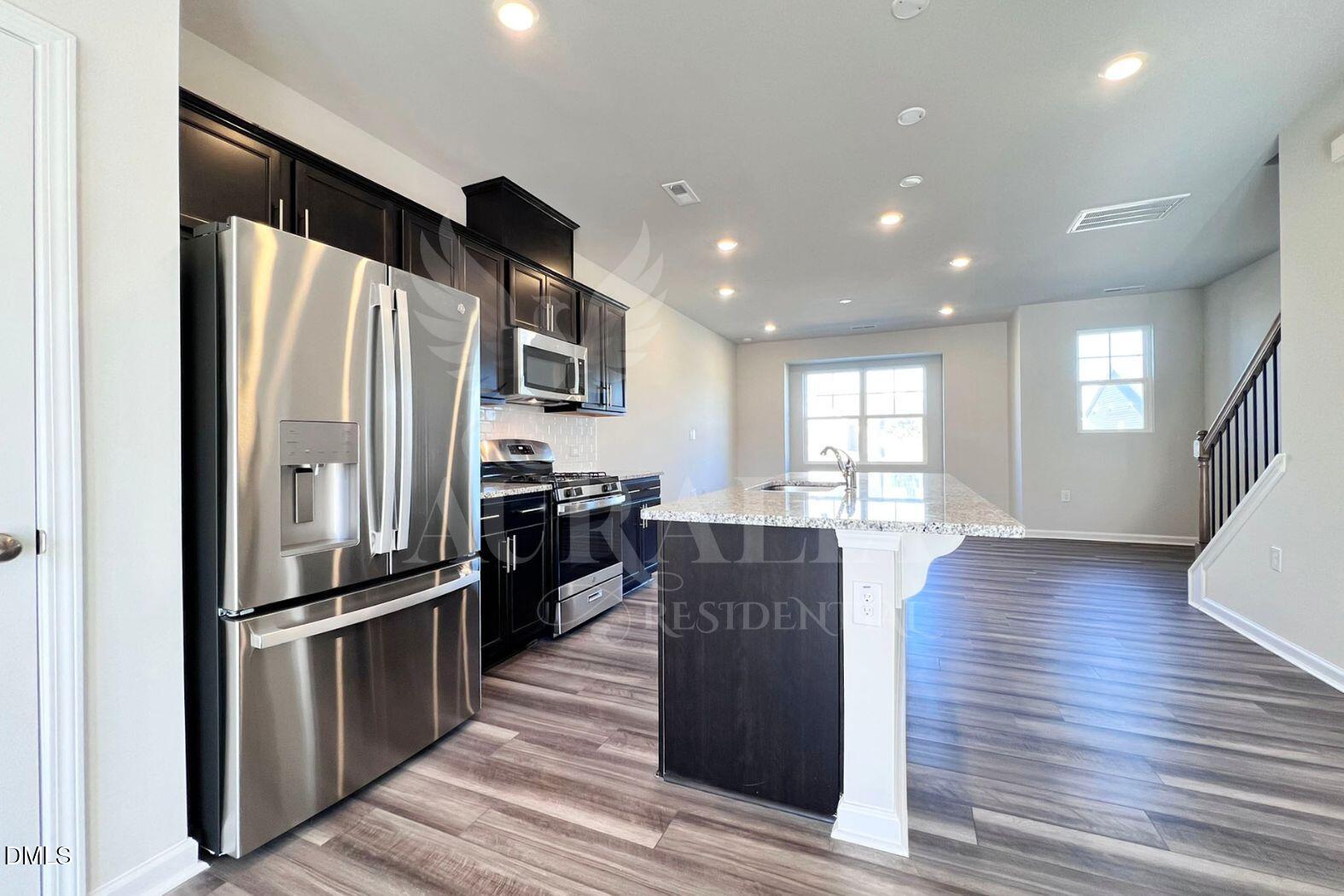181 Ivy Vine Way Raleigh, NC 27610 - Photo 8 of 22 a kitchen with stainless steel appliances granite countertop a refrigerator and a stove