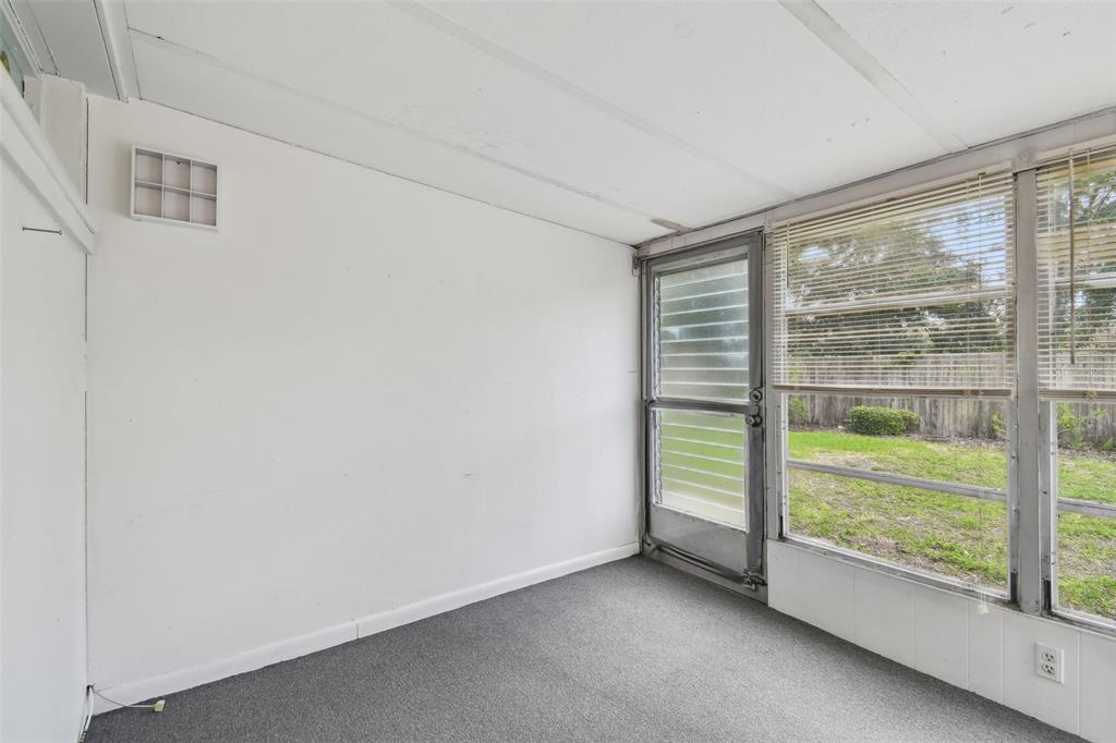 8319 Annwood Road Seminole, FL 33777 - Photo 20 of 27 a view of an empty room with wooden floor and a window