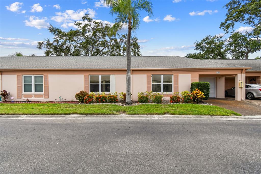 8319 Annwood Road Seminole, FL 33777 - Photo 26 of 27 a front view of a house with a garden