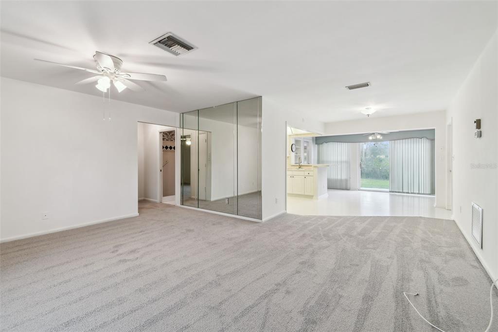 8319 Annwood Road Seminole, FL 33777 - Photo 3 of 27 a view of an empty room with a window and a kitchen