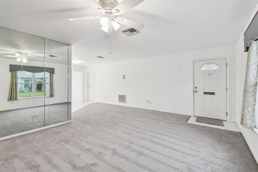 8319 Annwood Road Seminole, FL 33777 - Photo 5 of 27 an empty room with fan and entrance