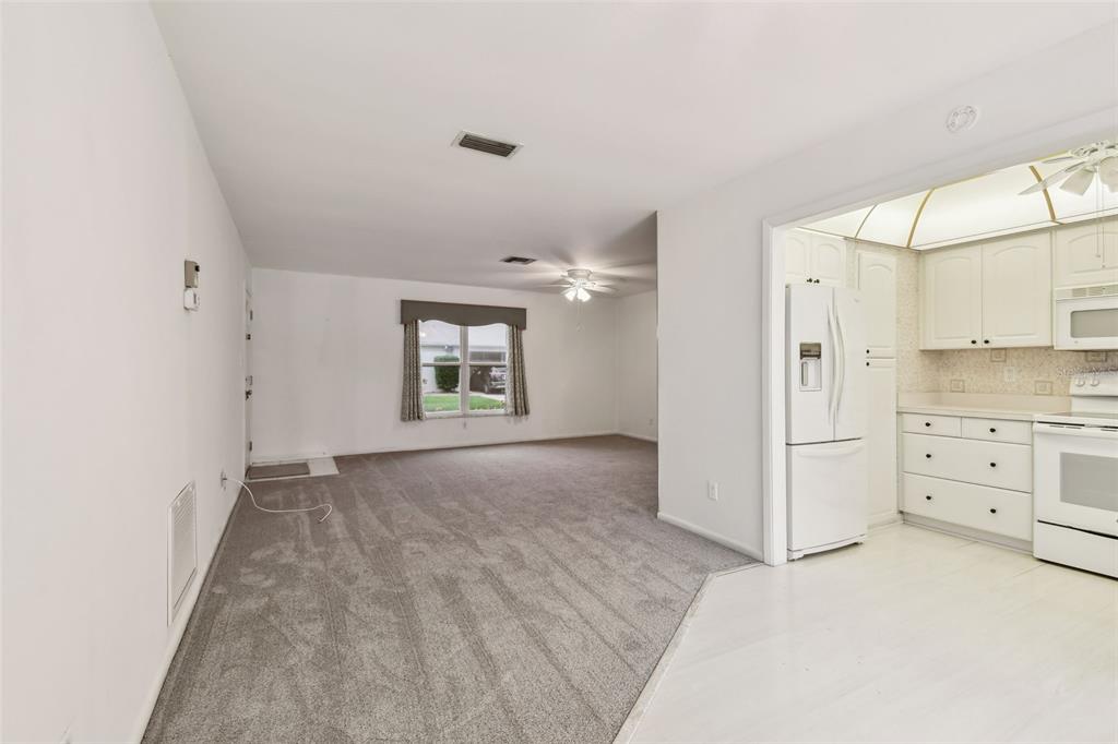 8319 Annwood Road Seminole, FL 33777 - Photo 6 of 27 a view of a kitchen with white cabinets and wooden floor