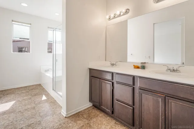 a bathroom with a sink vanity and mirror