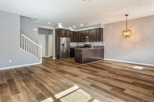 a view of kitchen and kitchen with microwave