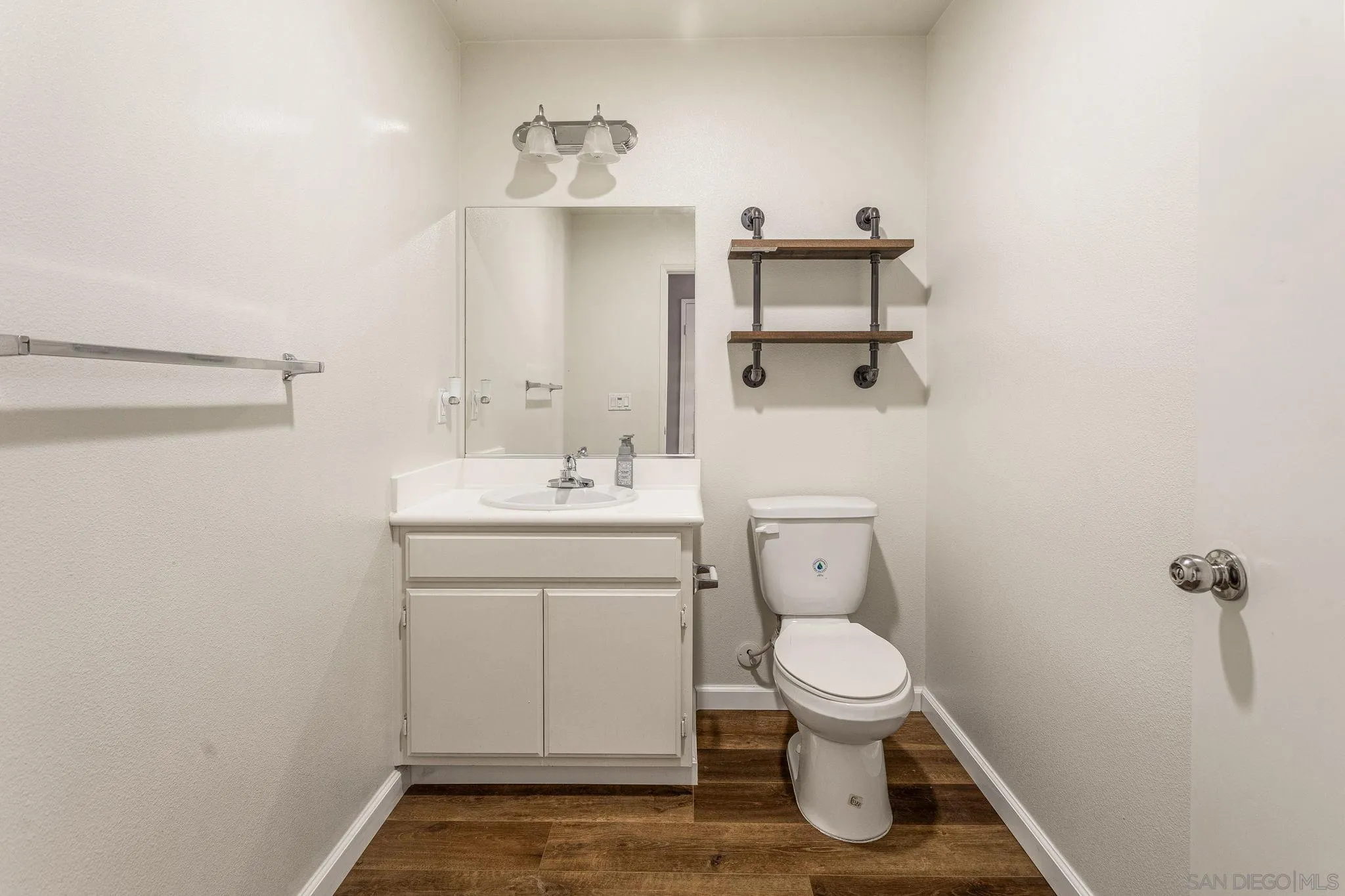 1520 Santa Carolina Road, Unit 4 Chula Vista, CA 91913 - Photo 6 of 15 a bathroom with a toilet sink and mirror