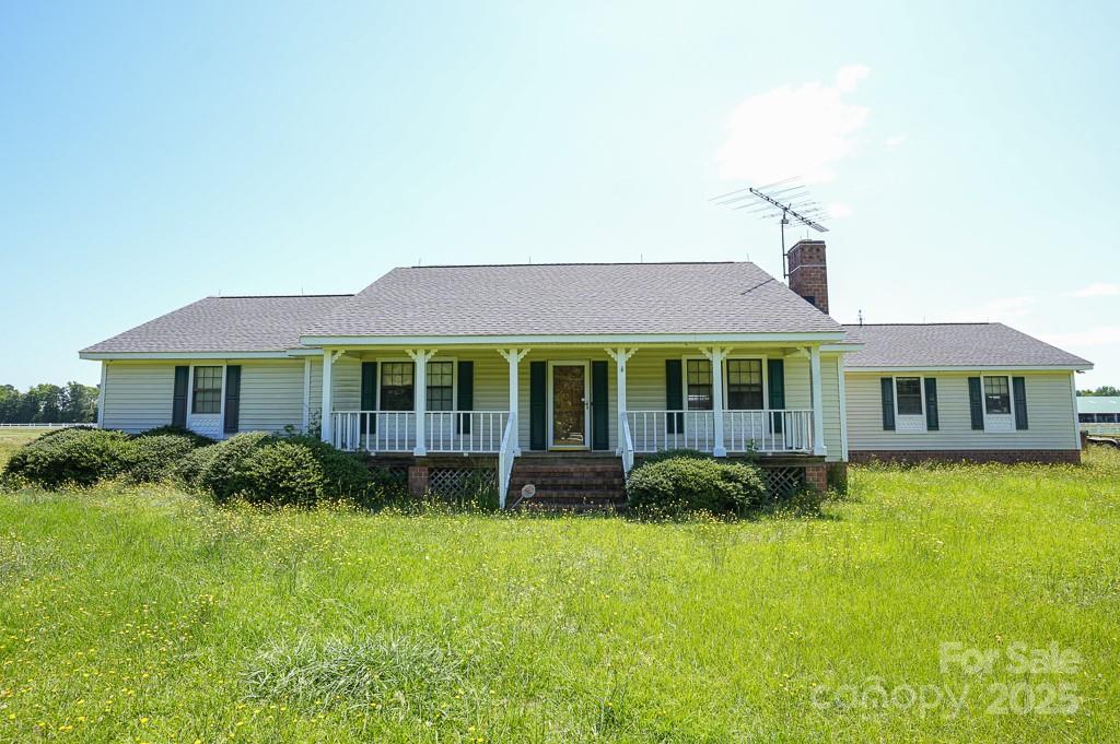 9167 Hasty Road Laurinburg, NC 28352 - Photo 34 of 48 a front view of a house with a yard