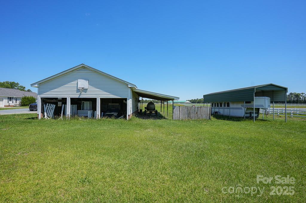 9167 Hasty Road Laurinburg, NC 28352 - Photo 36 of 48 a front view of a house with a garden