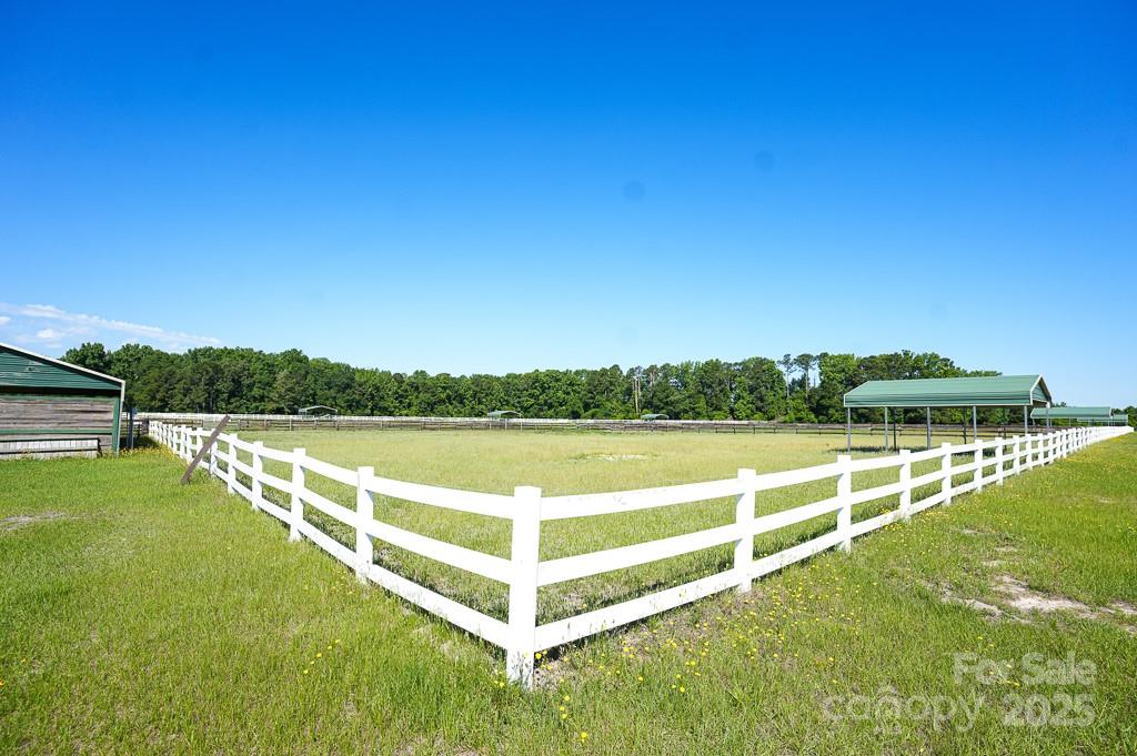 9167 Hasty Road Laurinburg, NC 28352 - Photo 40 of 48 a view of a lake with houses in the back