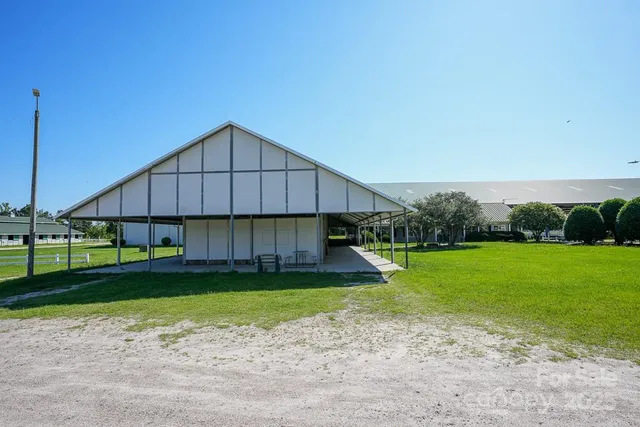 a house that has a big yard with wooden fence