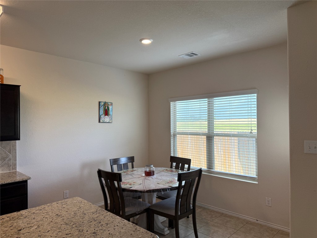 352 Circle Way, Unit 37E Jarrell, TX 76537 - Photo 11 of 39 a view of a dining room with a table and chairs