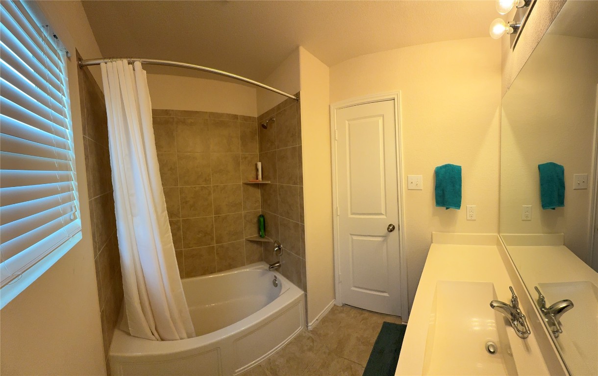 352 Circle Way, Unit 37E Jarrell, TX 76537 - Photo 18 of 39 a bathroom with a tub and shower
