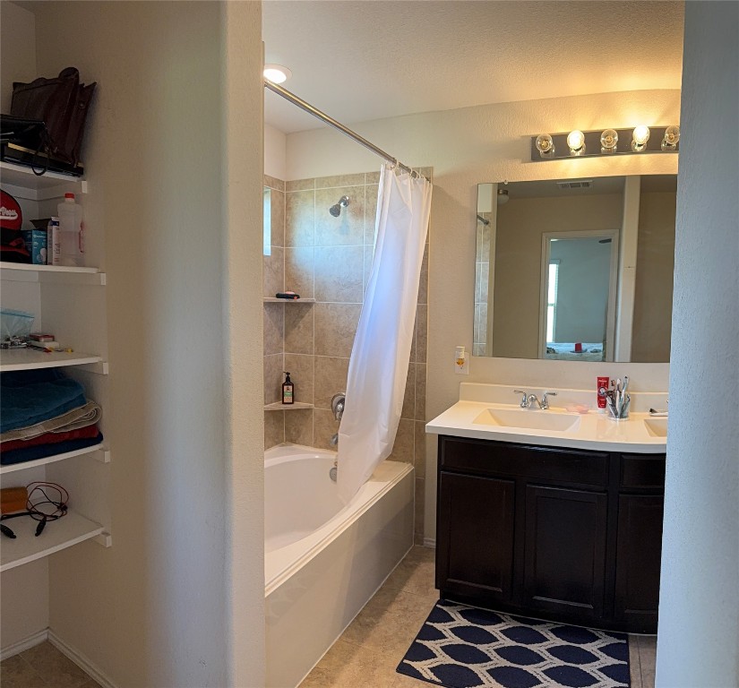 352 Circle Way, Unit 37E Jarrell, TX 76537 - Photo 27 of 39 a bathroom with a tub sink and mirror