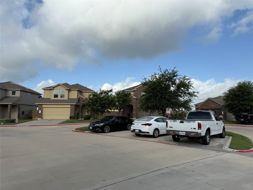 352 Circle Way, Unit 37E Jarrell, TX 76537 - Photo 35 of 39 a view of a cars parked in front of a building