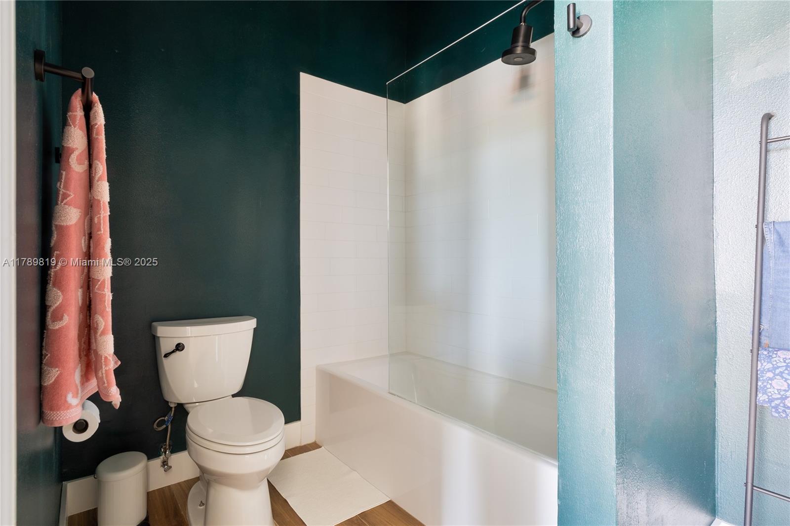 3062 Bird Avenue, Unit C1 Miami, FL 33133 - Photo 12 of 13 a bathroom with a toilet and a shower curtain