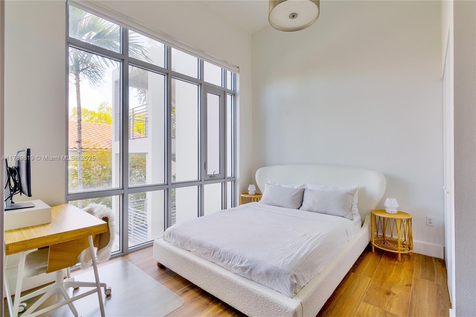 3062 Bird Avenue, Unit C1 Miami, FL 33133 - Photo 7 of 13 a bedroom with a bed and a table