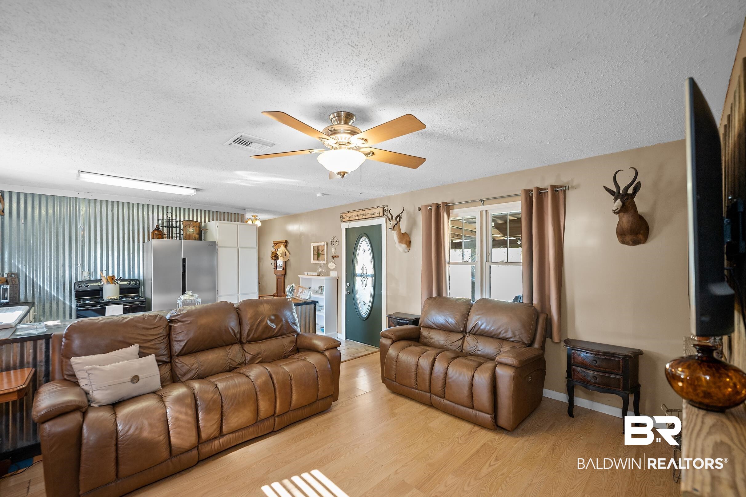 110 Sam Jones Road Atmore, AL 36502 - Photo 14 of 47 Living area with a textured ceiling, ceiling fan, and light wood-style floors