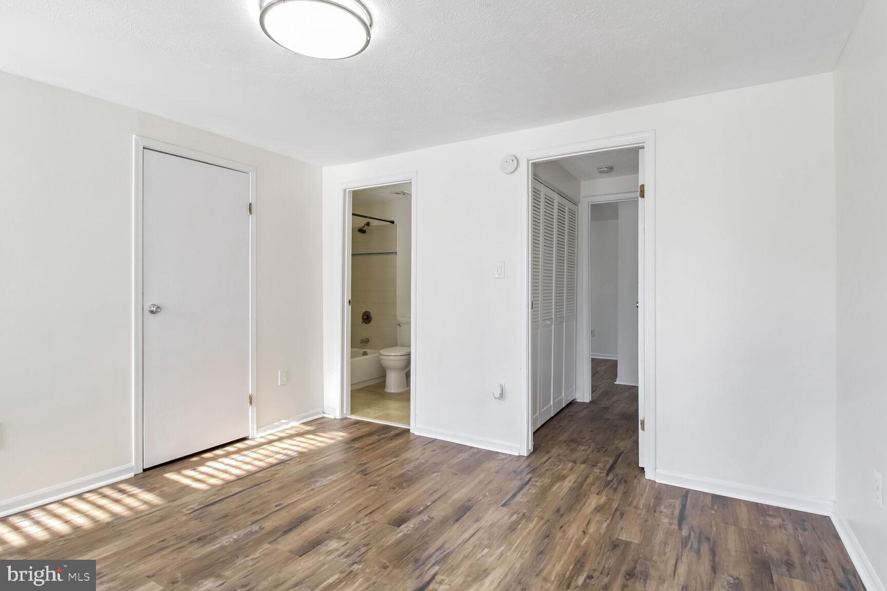 5964 Watch Chain Way, Unit 12102 Columbia, MD 21044 - Photo 14 of 20 an empty room with wooden floor and windows