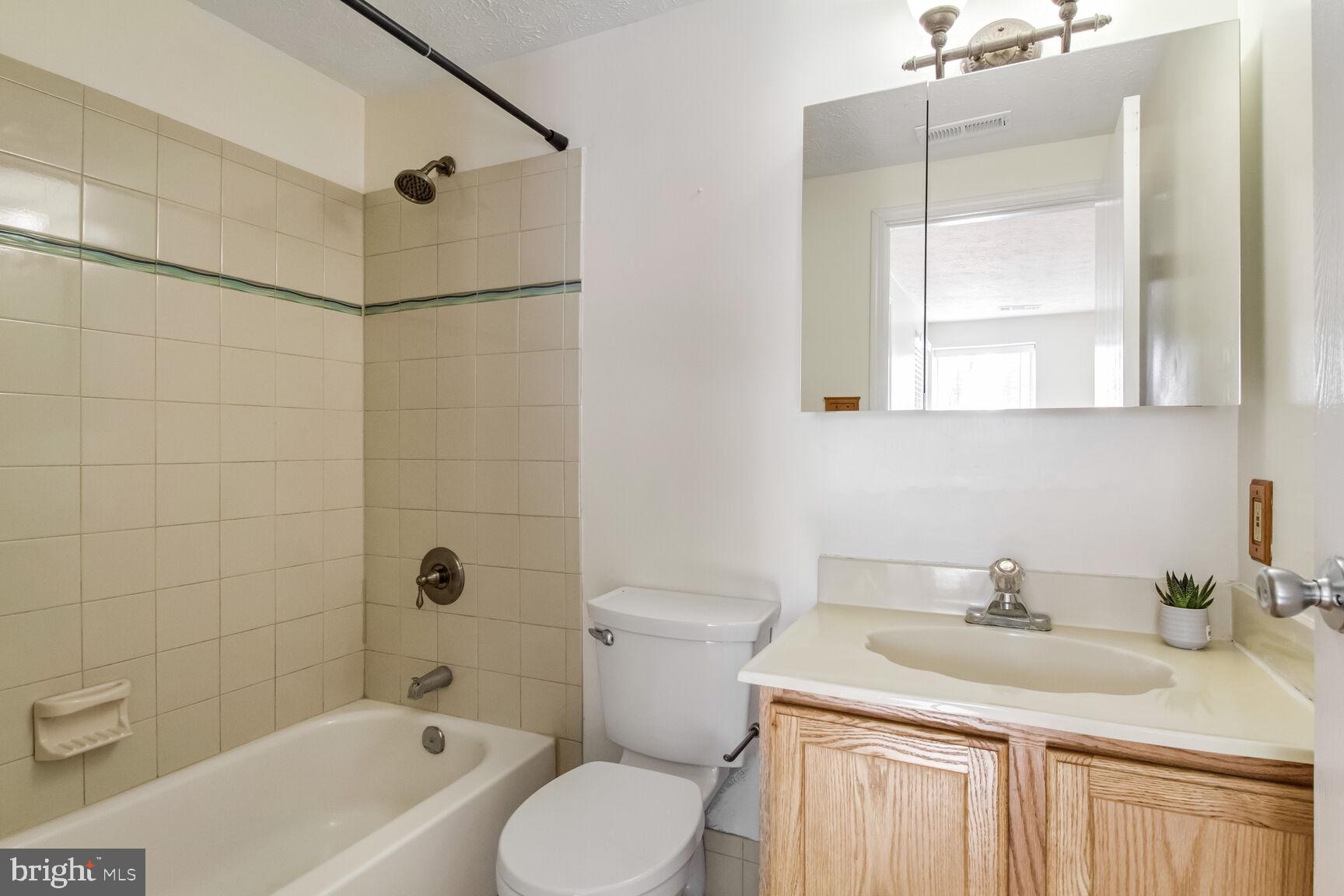 5964 Watch Chain Way, Unit 12102 Columbia, MD 21044 - Photo 16 of 20 a bathroom with a sink toilet and shower