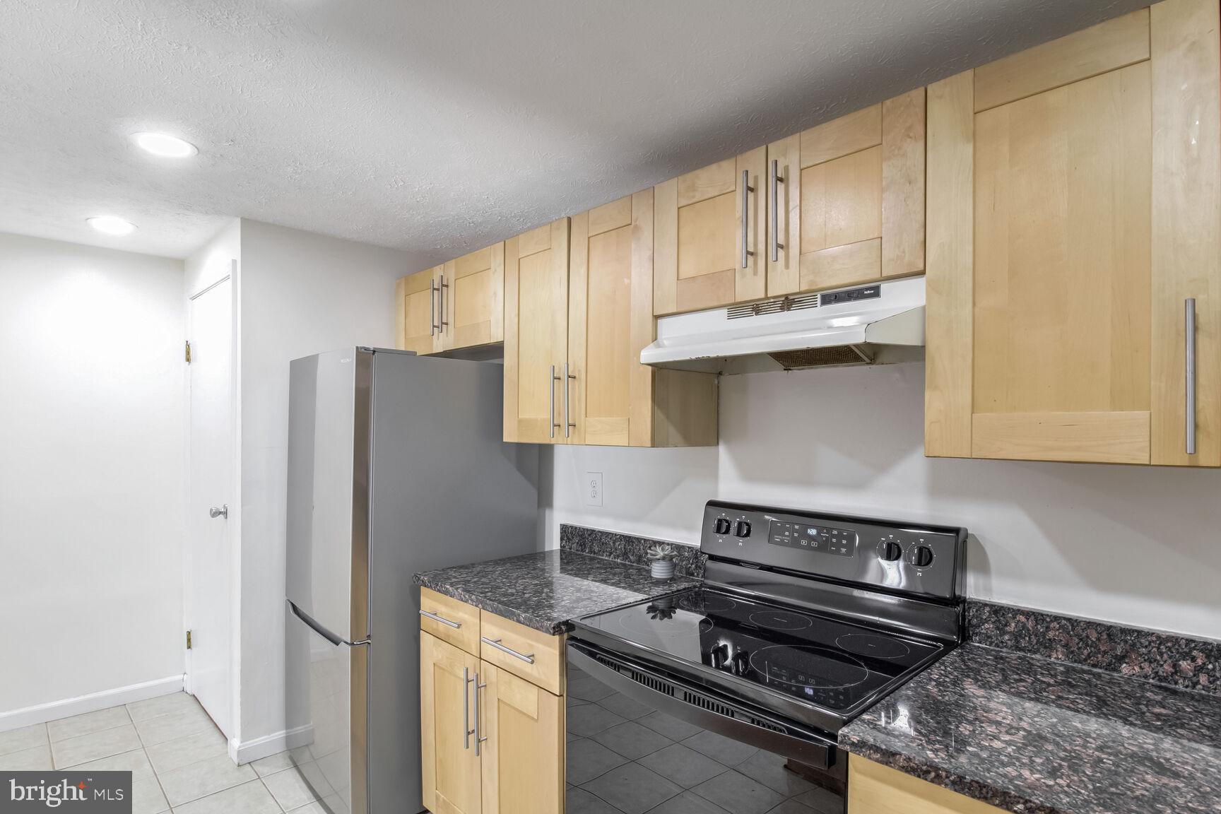 5964 Watch Chain Way, Unit 12102 Columbia, MD 21044 - Photo 10 of 20 a kitchen with stainless steel appliances granite countertop a refrigerator and a stove top oven