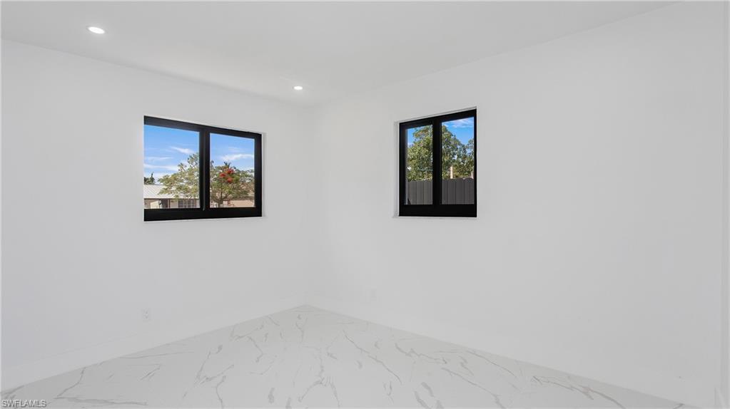 5477 Martin Street Naples, FL 34113 - Photo 13 of 21 an empty room with windows