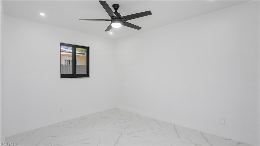 5477 Martin Street Naples, FL 34113 - Photo 14 of 21 an empty room with a window and a fan