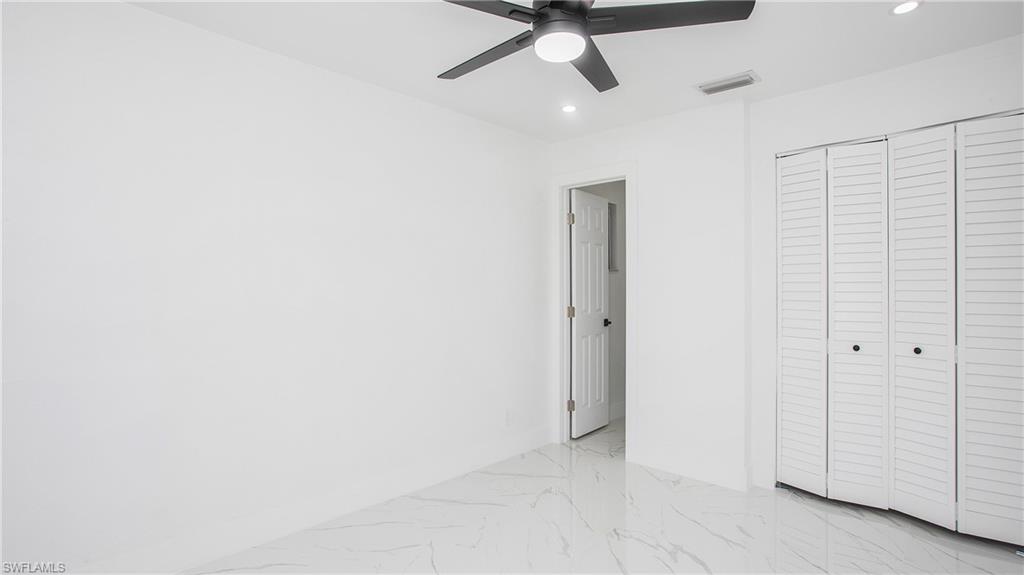 5477 Martin Street Naples, FL 34113 - Photo 15 of 21 an empty room with ceiling fan