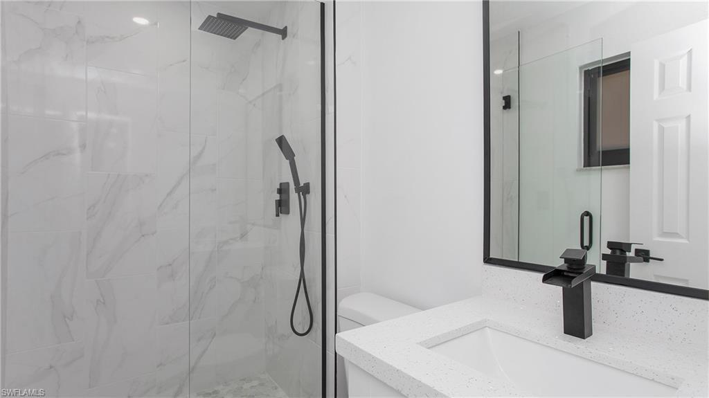 5477 Martin Street Naples, FL 34113 - Photo 16 of 21 a bathroom with a sink