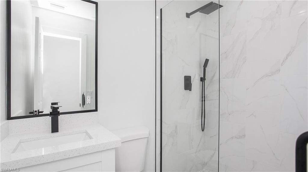 5477 Martin Street Naples, FL 34113 - Photo 17 of 21 a bathroom with a sink