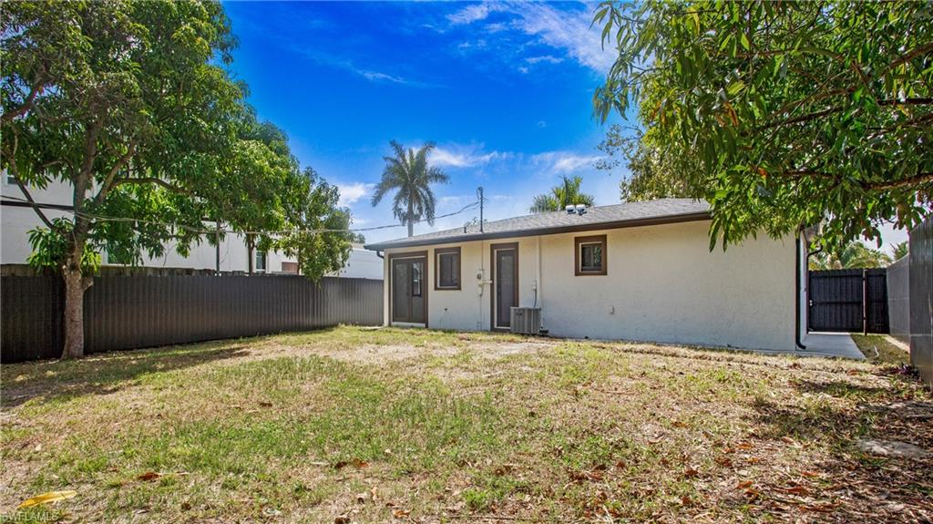 5477 Martin Street Naples, FL 34113 - Photo 19 of 21 a view of a house with a yard