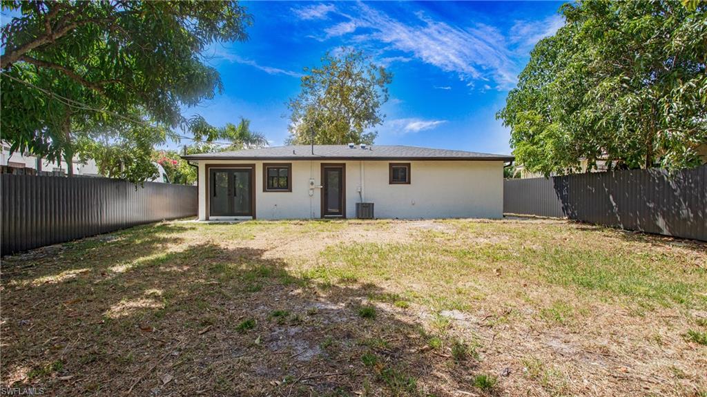 5477 Martin Street Naples, FL 34113 - Photo 20 of 21 a view of a house with a yard